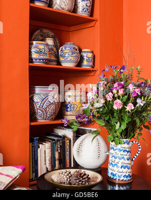 Jug by Jaqueline Layton Boyce on side table by open shelving displaying Poole pottery. The wall colour is Charlottes Stock Photo