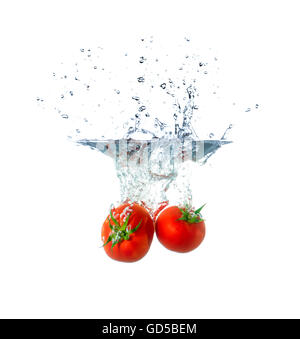 Fresh Tomato Fruits Sinking in Water Isolated on White Background Stock Photo