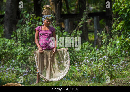 Tharu woman in nepali terai wearing traditional clothing to go fishing Stock Photo