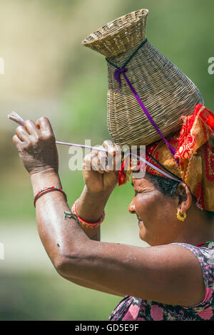 Tharu woman in nepali terai wearing traditional clothing to go fishing Stock Photo