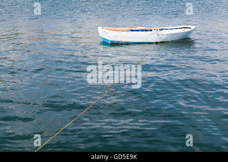 White wooden fishing boat floats on still water of Marmara Sea, Istanbul, Turkey Stock Photo