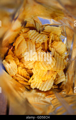 Looking into a half empty bag of potato crisps. Stock Photo