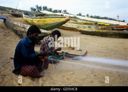 Fishermen making nets Stock Photo