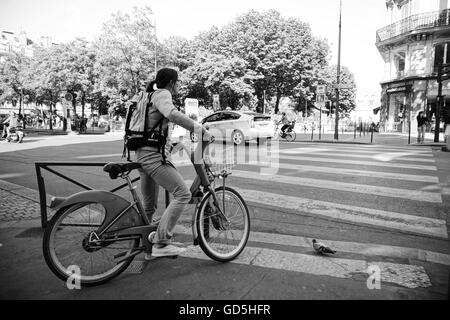 Women on bicycle pigeon in streets of paris, france, europe