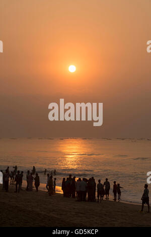 Tourists on beach at sunrise, Puri, Orissa, Odisha, India, Asia Stock Photo