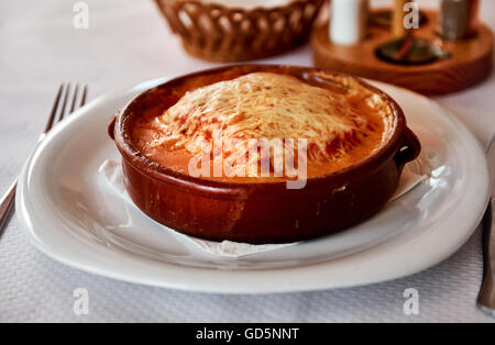 Baked lasagna in a bowl at restaurant Stock Photo