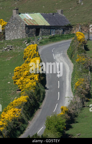 Winding, narrow, seep rural roads along the Northern Irish coast Stock Photo