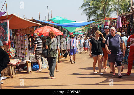 Shoppers at the Wednesday flea market in Anjuna Beach, Goa, India, looking for varieties of merchandise. Stock Photo