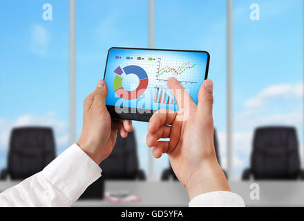 hand holding digital tablet pc with stock chart Stock Photo