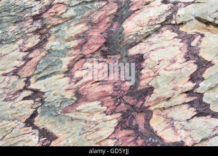 Close up of colorful rock surface, natural background, pattern and texture. Metamorphic white quartzite folded and fractured tog Stock Photo