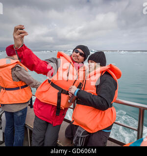 Couple taking a self portrait, Jokulsarlon Glacial Lagoon, Breidamerkurjokull, Vatnajokull Ice Cap, Iceland Stock Photo