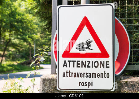 Warning plate that alerts the possible passage of toads. The sign says: Beware toads crossing Stock Photo