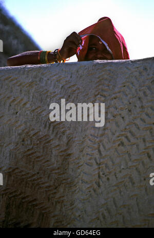 Woman behind wall Stock Photo