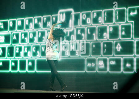 Female Contemporary Dancer performs in front of a computer keyboard backdrop Stock Photo