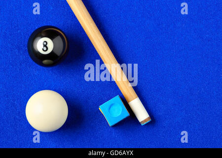 Billiard balls, cue and chalk on a blue pool table. Viewed from above. Horizontal image. Stock Photo