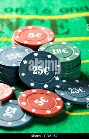 Poker chips on a poker table close-up. Vertical image. Stock Photo
