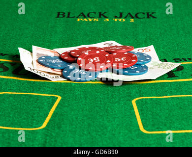 Poker chips and bills at a poker table. Horizontal image. Stock Photo