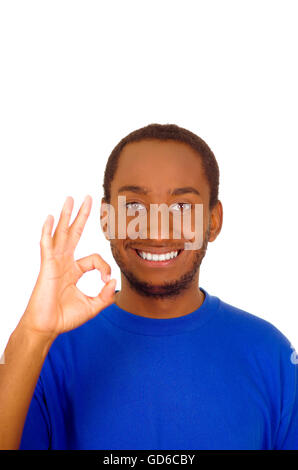 Headshot handsome man wearing strong blue colored t-shirt making circle with fingers smiling to camera Stock Photo