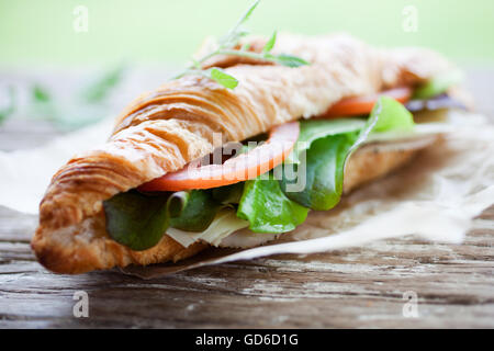 Fresh homemade croissant with ham and salad Stock Photo