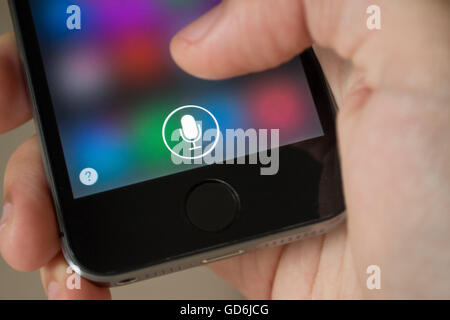 Bangkok, Thailand - September 25, 2014 : Apple iPhone5s held in one hand showing its screen with Siri application icons. Stock Photo