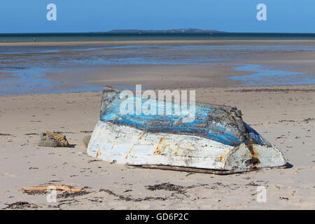 Old blue and white fishing boat at the beach of Vilankulo Stock Photo