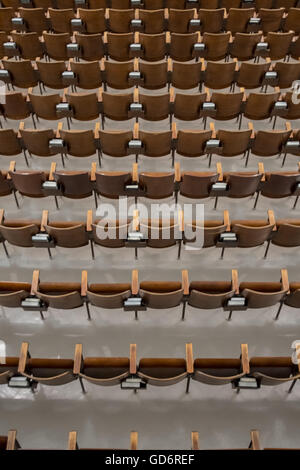 Antique Wood Auditorium Seats Above View From Behind in old chapel Stock Photo