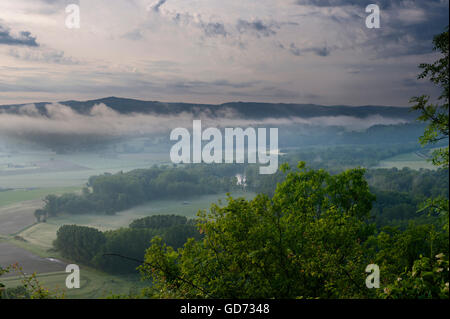 Misty dawn over floodplain of l'Allier River from Pic de Nonette, a butte (steep hill) in village of Nonette, Auvergne, France Stock Photo