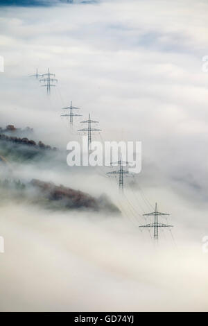 Aerial view of electric pylons look from the low clouds in Bestwig, transmission lines in the fog, electricity, power line, land Stock Photo