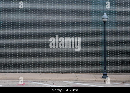Black Brick Wall With Light Post and copy space Stock Photo