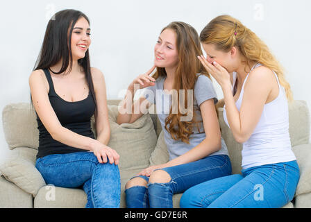 Portrait of three happy pretty young women at home Stock Photo