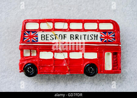 UK, England, London, Souvenir Fridge Magnet of red London double decker bus, first broken and then glued Stock Photo