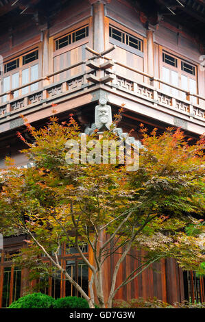 A red maple tree in front of a wooden building at baoshan buddhist temple located in the baoshan district of shanghai china. Stock Photo