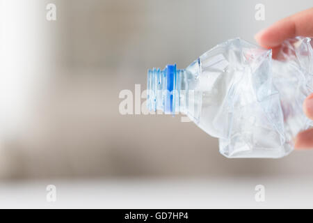 close up of hand holding used plastic bottle Stock Photo