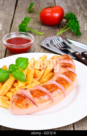 Sausage on the Grill with Pasta and Basil Stock Photo