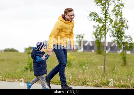 happy father and little son walking outdoors Stock Photo