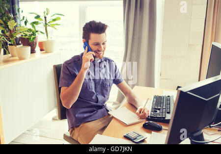 happy creative male worker calling on smarphone Stock Photo