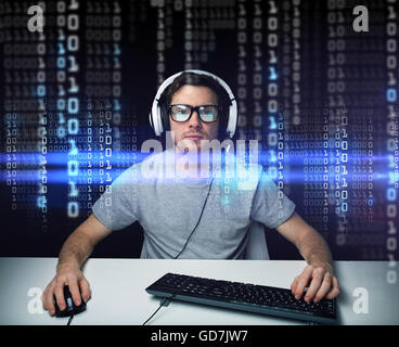 man in headset hacking computer or programming Stock Photo