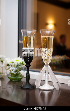Two wedding glasses decorated in the style of the bride and groo Stock Photo