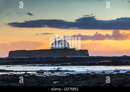 St. Cwyfan's Church at sunset on Anglesey Wales Uk Stock Photo