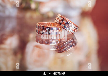 A pair of wedding rings with bokeh background Stock Photo