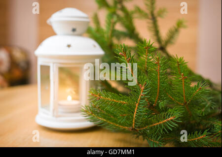Snowy blue lantern and Christmas balls on the background of fir Stock Photo