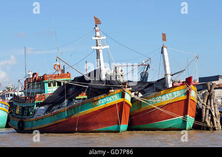 small fishing motor boats lined up in a fishing sea harbor in the evening  with puffy clouds in the sky Stock Photo - Alamy