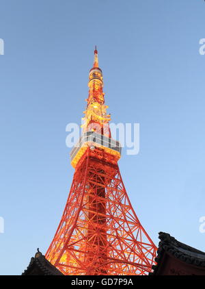 Iconic Tokyo Tower over Japanese kawara roof in Tokyo Japan. Stock Photo