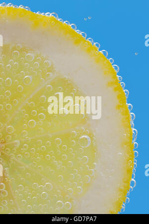 Lemon Slices deeply under water and bubbles Stock Photo