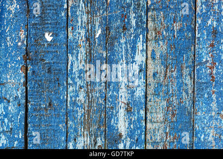 Old shabby wooden fence background with a trace of ads. Stock Photo