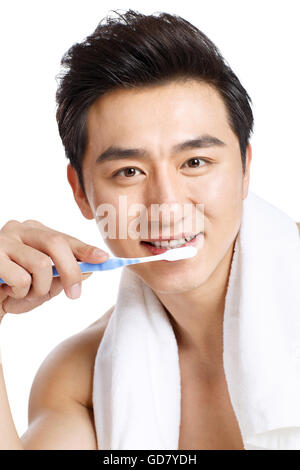 Young men are brushing his teeth Stock Photo