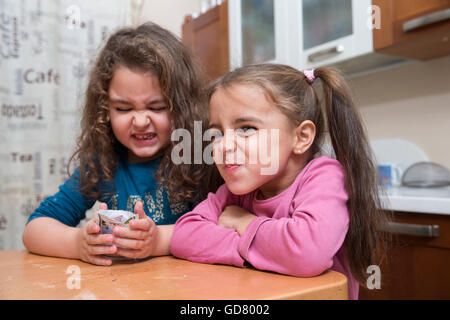 Two sisters making faces while looking at camera Stock Photo