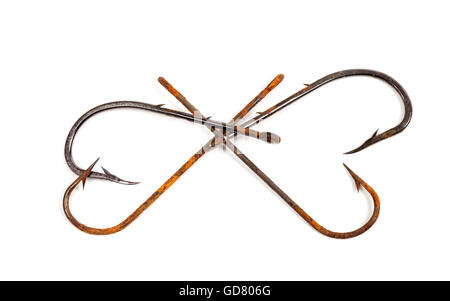 Old rusty fish hooks in form of hearts isolated on white background Stock Photo