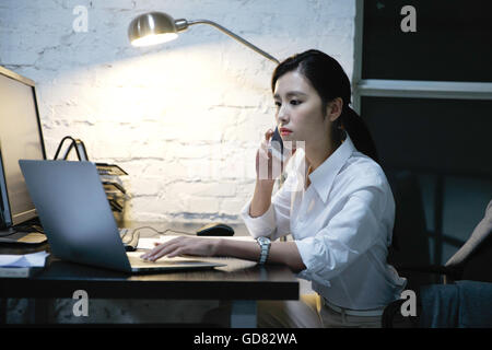 Female white-collar workers to work overtime Stock Photo