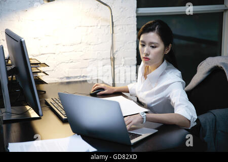 Female white-collar workers to work overtime Stock Photo